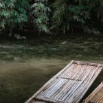 White-Water Rafting - Two Long Bamboo Rafts by The Side Of A Shallow River