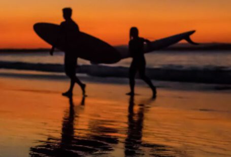 Noosa - Two Surfers at the Seashore during Sunset