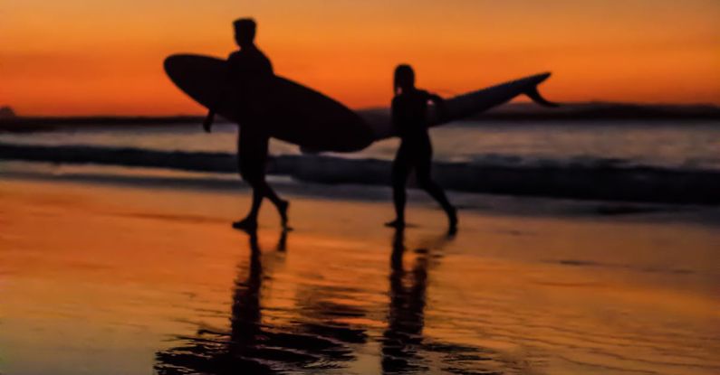 Noosa - Two Surfers at the Seashore during Sunset
