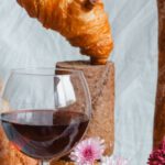 Cheese Regions - A glass of wine and bread with flowers