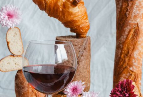 Cheese Regions - A glass of wine and bread with flowers