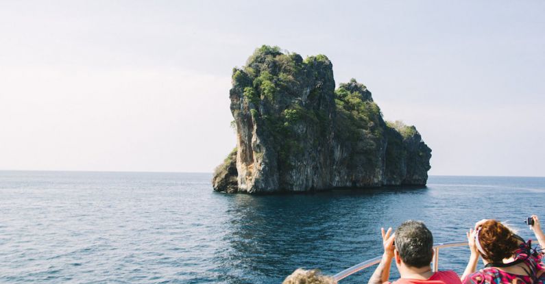 Island Hopping - People on Rock by Sea