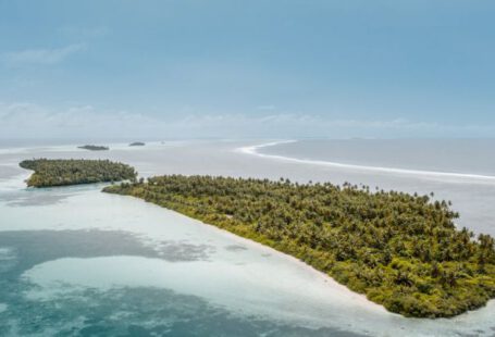 Uninhabited Islands - Drone view of uninhabited tropical islands covered with lush greenery located in shallow sea under blue sky